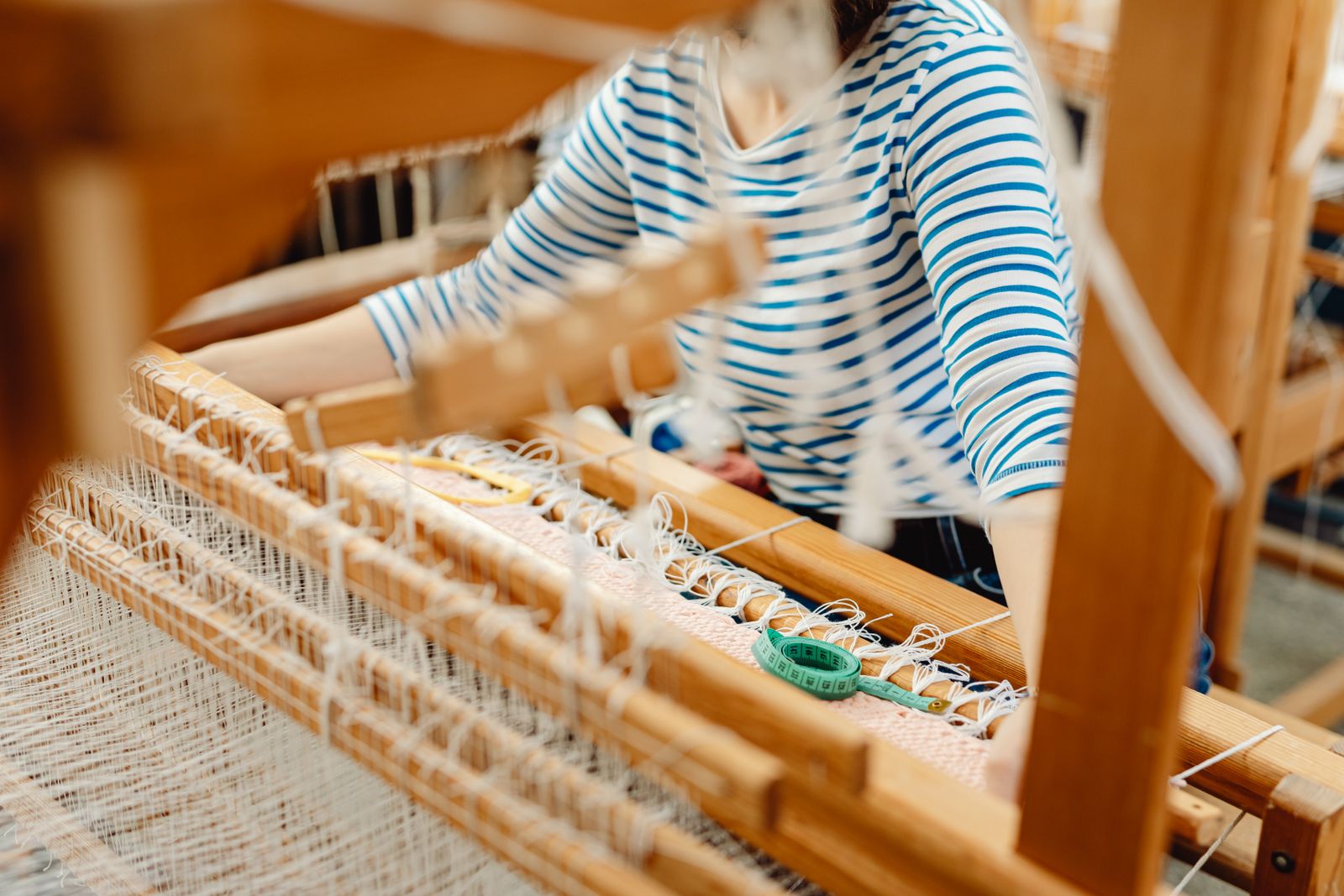 Wool fiber batts prepared by carding showing the lofty loosely arranged preparation ready for woolen spinning