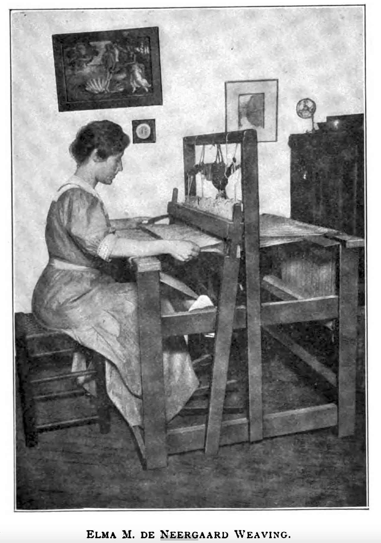 Historical photograph of a woman weaving at a loom, cloth building on the breast beam in an even, consistent weave structure